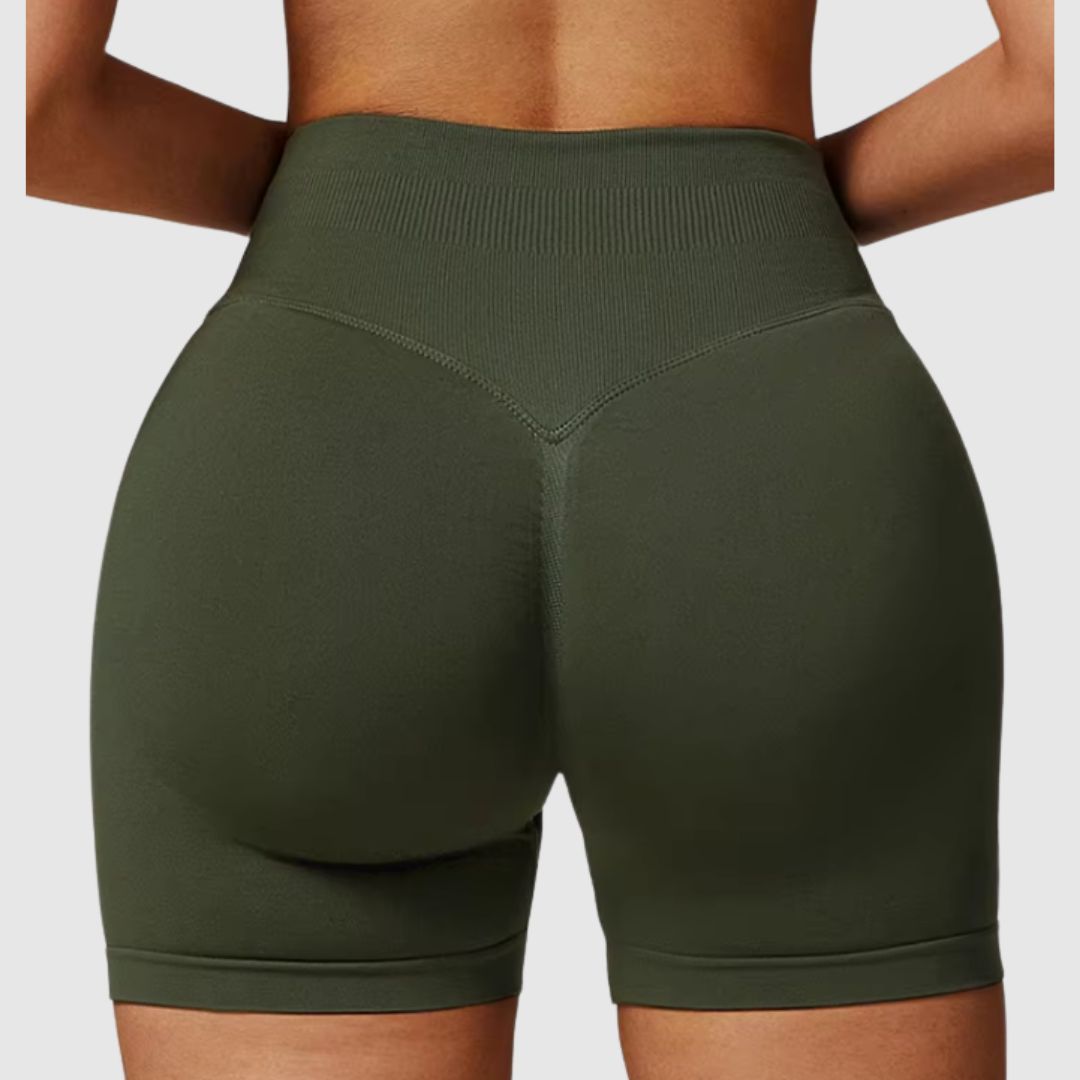 Back view of Vibe Scrunch Shorts dark green worn by model in active workout setting