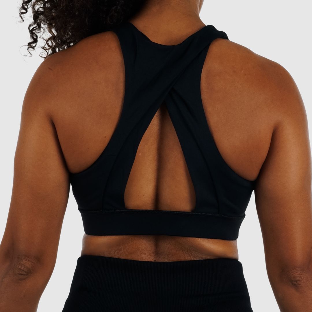 Back view of Black Sports Bra Racerback on model. Shows supportive wide cross-back strap design for high-impact training