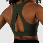 Back view of Olive Green Racerback Sports Bra on model. Highlights wide cross-strap design for maximum support and mobility