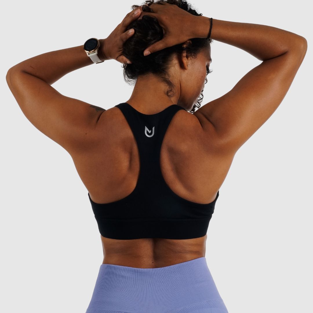Black racerback sports bra providing versatile support for workouts and casual wear