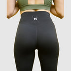 Flared Leggings Black worn by model in workout setting emphasising high waist and full-length flare