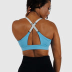 Light Blue bra with straps worn straight over shoulders.
