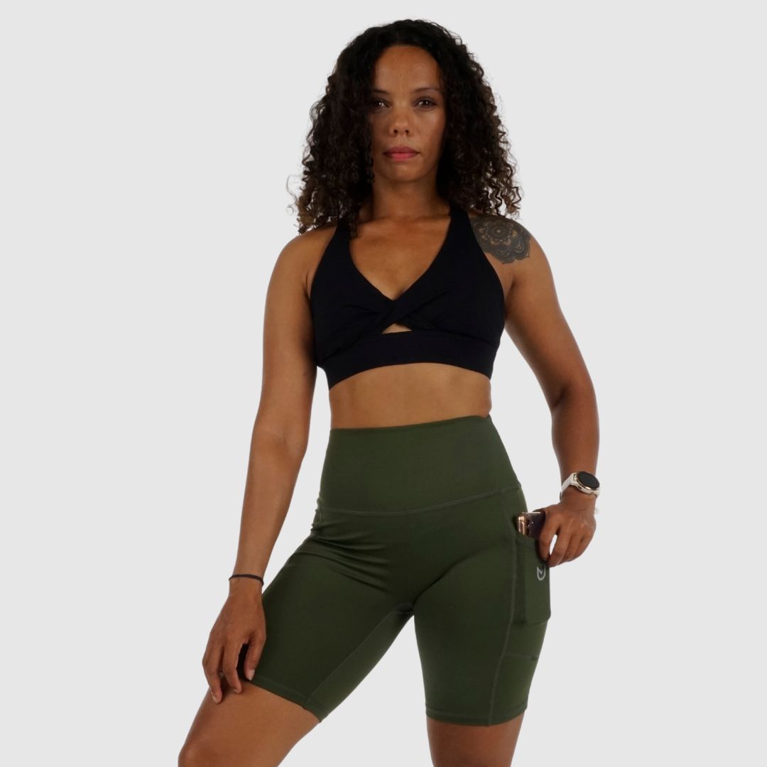 Olive Green shorts and black top, showing full side profile.