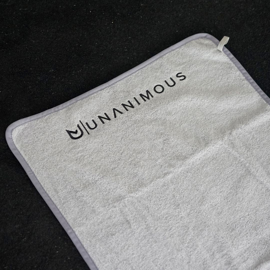Soft, high-quality 400 GSM cotton towel, rolled for gym bag storage.