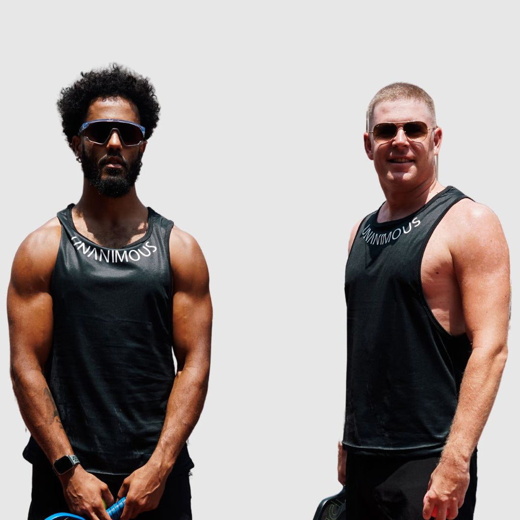 Two men wearing the black muscle tank, highlighting comfortable loose fit.