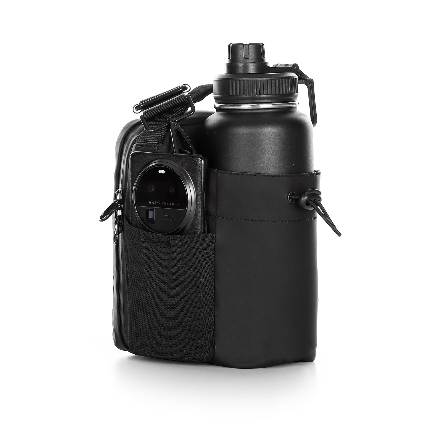 View inside the black gym sling bag with bottle compartment and organized storage.