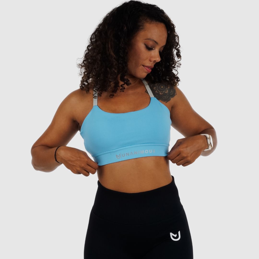 adjusting the band of the Light Blue Cross Sports Bra.