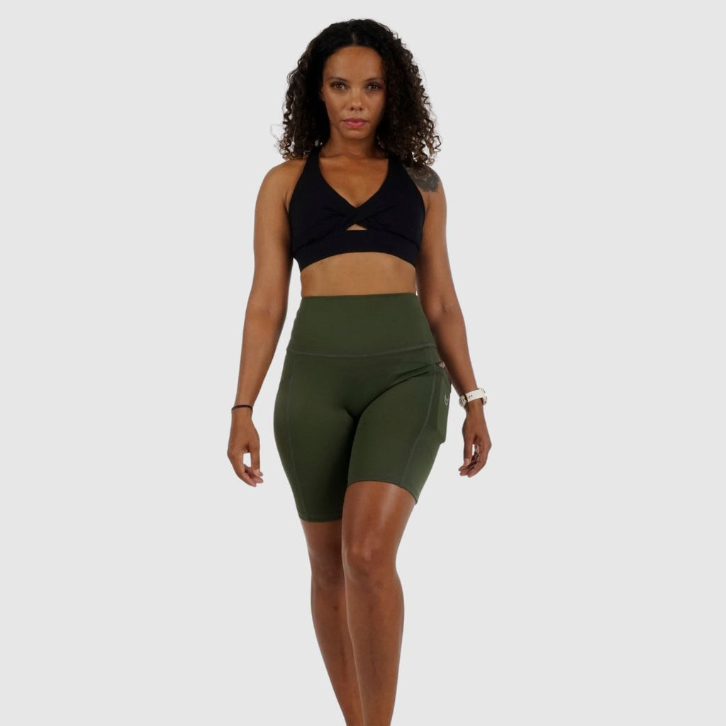 demonstrating flexibility in the comfortable Olive Green workout shorts.