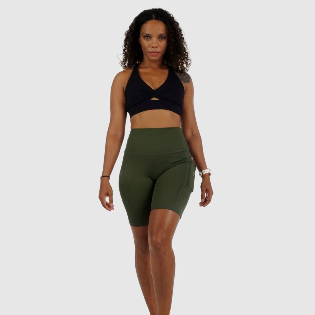 demonstrating flexibility in the comfortable Olive Green workout shorts.