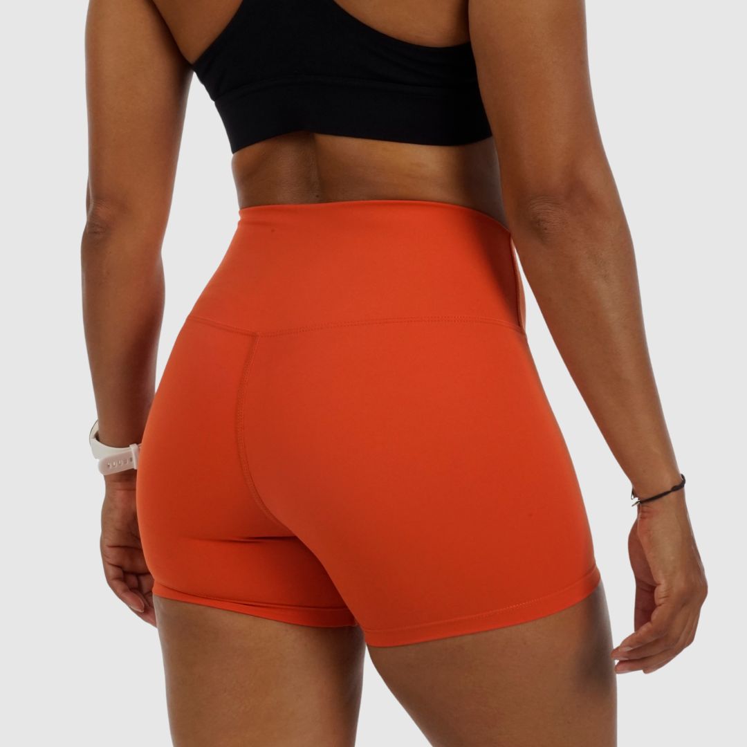 side view of Performance Shorts orange showing supportive fit and dynamic styling