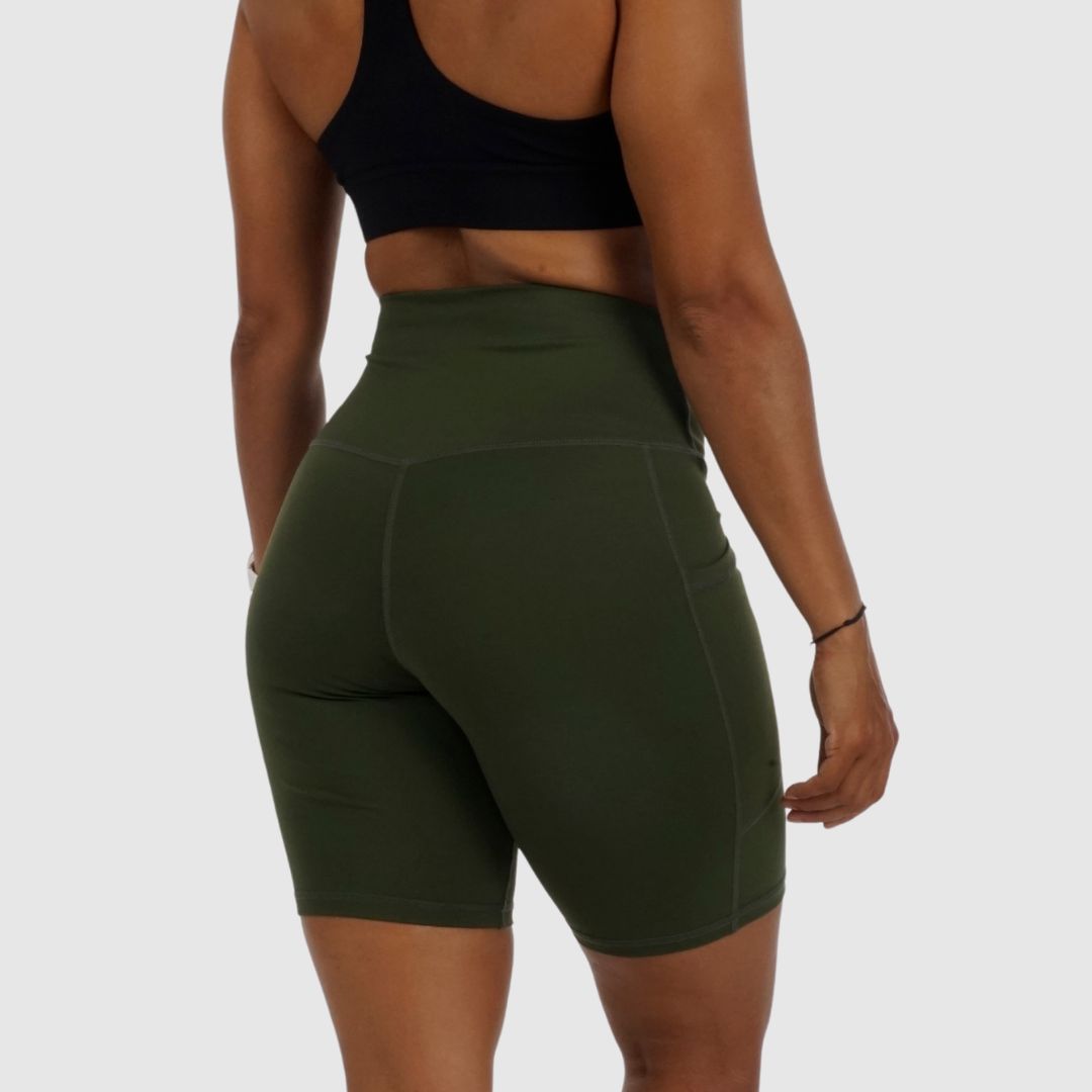 standing, rear view of the Olive Green compression cycling shorts.